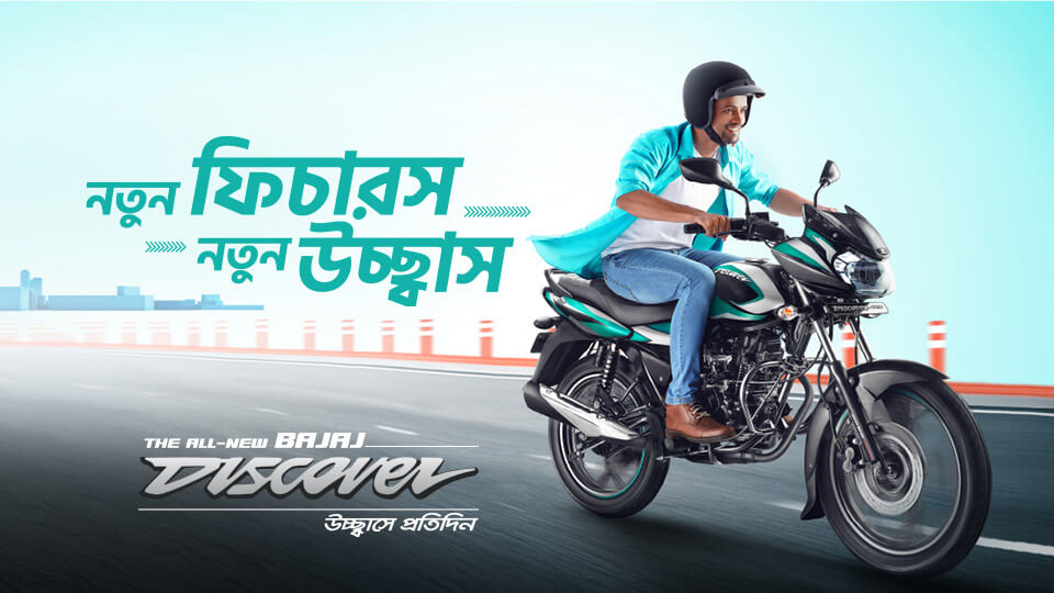 man riding black and green color bajaj discover 125cc disc motorcycle 2021 model on the road with black helmet